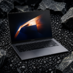 Alt Text: A Samsung laptop with a glowing screen display is positioned on dark, rough rocks.