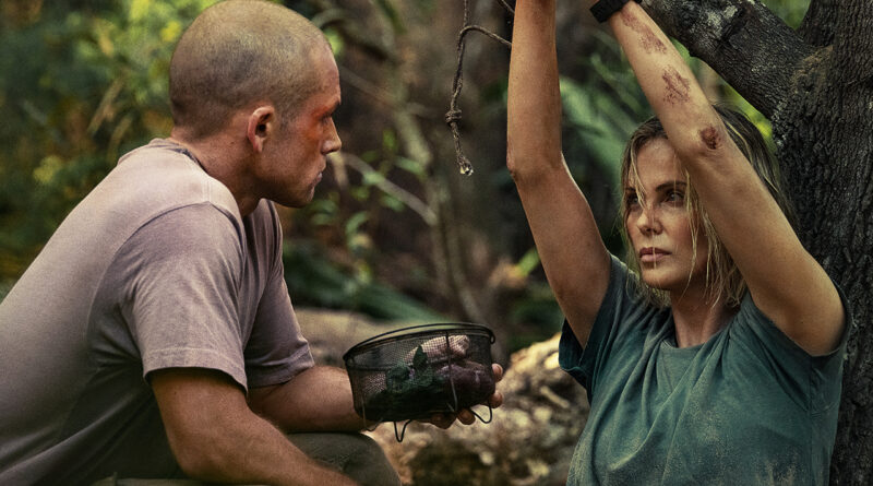 Charlize Theron's character and the man hunting her through the forest are standing face-to-face.