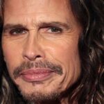 Close-up portrait of Aerosmith lead singer Steven Tyler looking directly at the camera with a neutral expression.